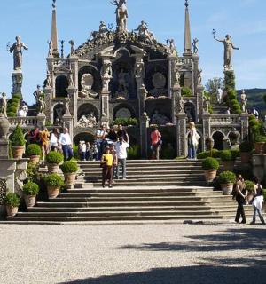 a group of people walking up the stairs to a building