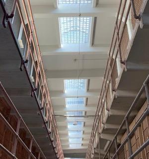 an empty hallway in a library with windows