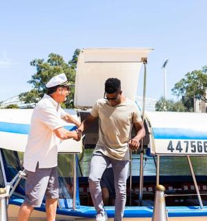 two men are standing next to a small plane