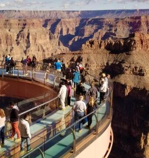 people on a viewing deck at the grand canyon