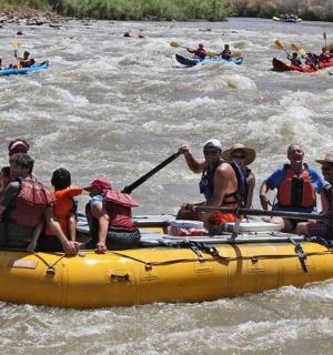 a group of people in a raft on a river