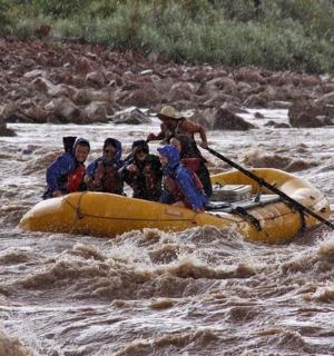 a group of people in a raft in a river