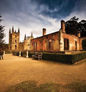 an old building with people walking in front of it