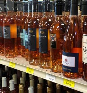a bunch of bottles of wine on a store shelf