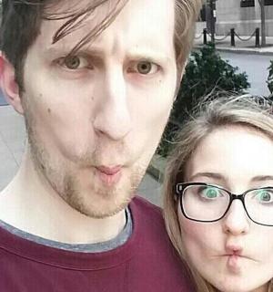 a man and a woman with glasses posing for a picture