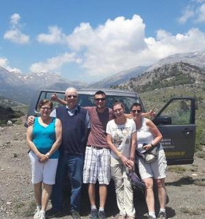 a group of people posing for a picture on a mountain