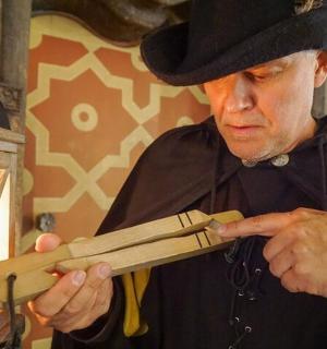 a man in a hat is holding a knife