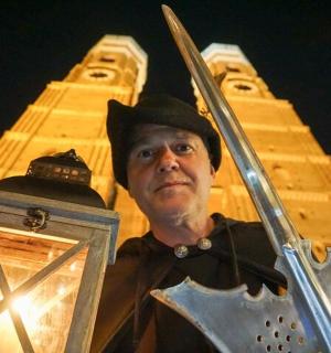 a man with a sword in front of a tower
