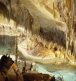 a painting of a cave with people in it