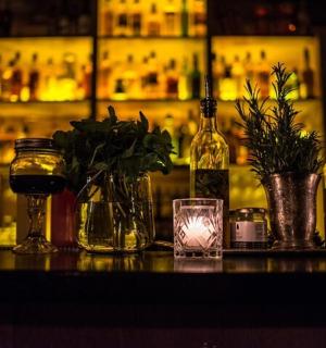 a bar with bottles and glasses on a table