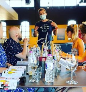 a group of people sitting around a table with wine glasses