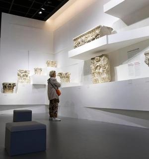 a group of people looking at a exhibit in a museum