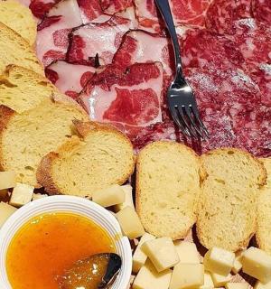 a plate of food with a pizza and bread and cheese