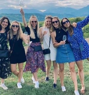 a group of women in dresses posing for a picture