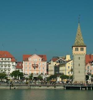 a city with a clock tower next to a body of water