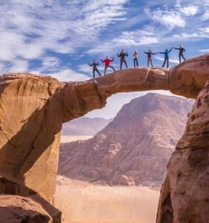 一群人跳过沙漠中的一座桥