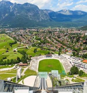 an aerial view of a city with mountains in the background