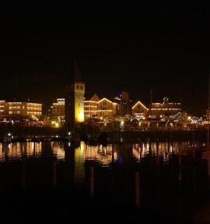 a city lit up at night with a clock tower