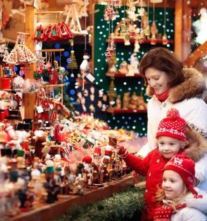 a woman and a child looking at a christmas display