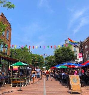 a group of people walking down a street with umbrellas