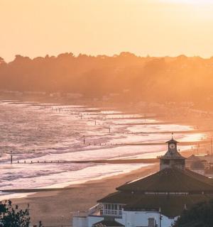a beach with a group of boats in the water