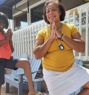 two women sitting on a bench doing yoga