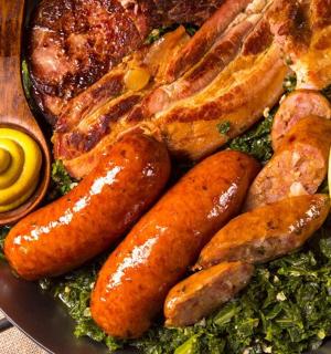 a plate of food with sausages sausage and other foods