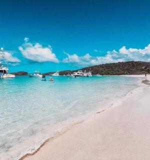 a boat in the water next to a beach