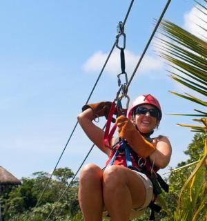a woman is sitting on a rope swing