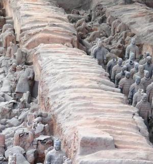 a large group of statues on a wall