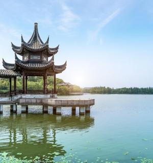 a pagoda sitting on top of a body of water