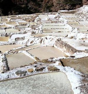 a field with rocks and snow on the ground