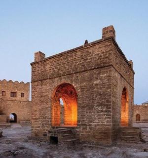an old brick building with fires in front of it