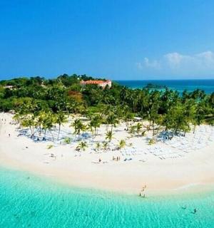 an island in the ocean with people on a beach