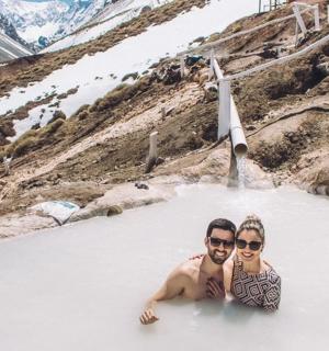 two men in a hot tub in a snowy mountain