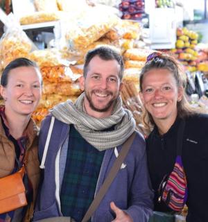 three people posing for a picture in a grocery store