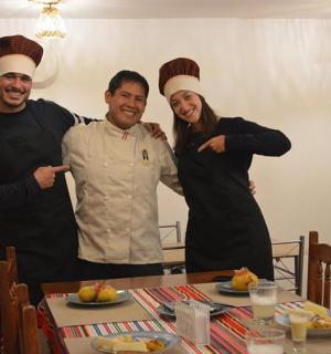 three chefs posing for a picture at a table