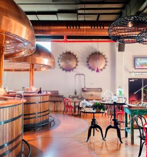 a restaurant with a woman sitting at a counter