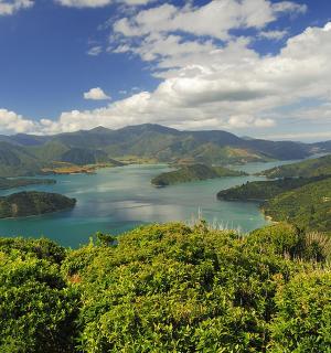 a view of a river in a valley with mountains