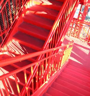 a red staircase with red risers in a building