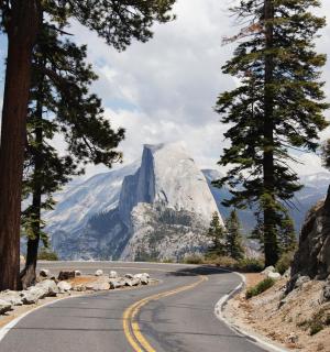 a winding road with a mountain in the background