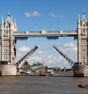 a bridge over the water with a boat under it