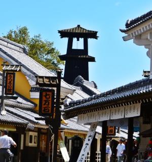 a group of buildings with people walking down a street