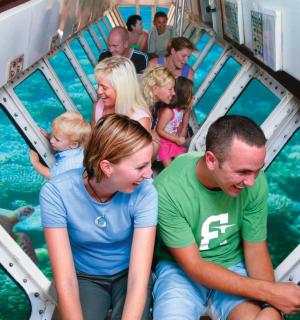a group of people on a ride at the aquarium