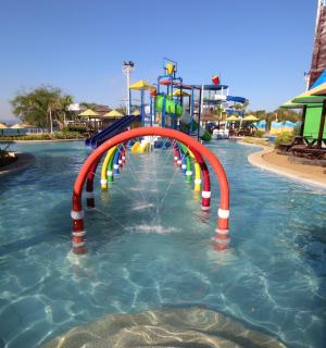 a water slide in a pool at a resort