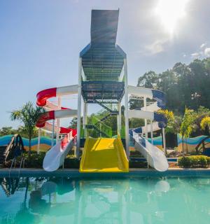 a water park with a water slide in a pool