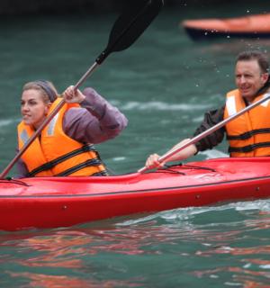 two people in a red kayak in the water