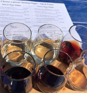 four glasses of wine sitting on top of a table