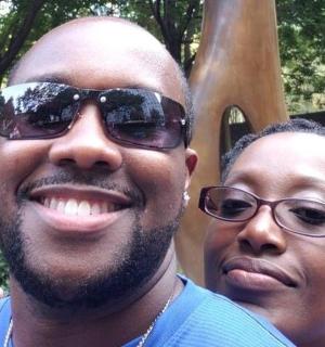 a man and a woman standing in front of a statue