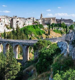 a bridge over a river with a city in the background